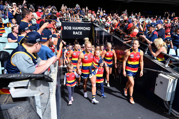 The Crows lead their team out of the race during the AFLW grand final match between the Adelaide Crows and the Brisbane Lions.