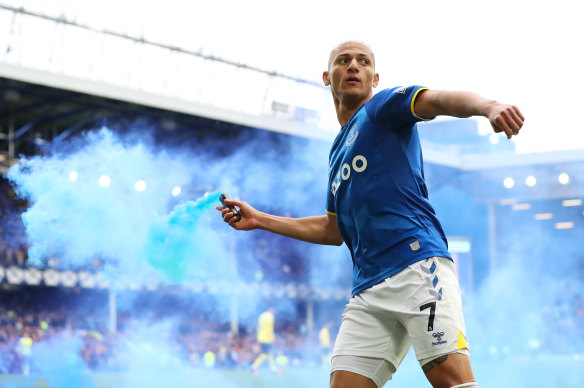 Richarlison pictured with a flare after scoring a goal. 