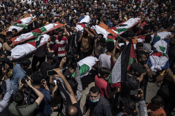 Palestinians attend the funeral of two women and eight children of the Abu Hatab family in Gaza City, who were killed by an Israeli air strike, on Saturday.