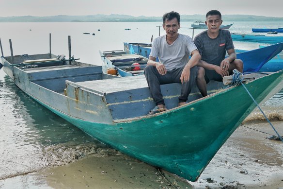 Trepang men Kasim (left) and Renaldy on a boat used to reach the Australian mainland. 