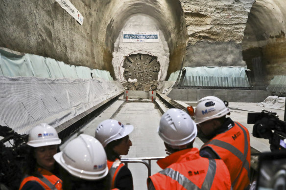 Premier Gladys Berejiklian joins workers to watch a giant boring machine break through at North Sydney on Monday.