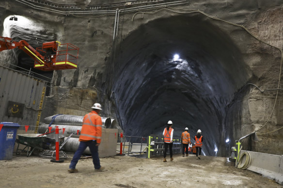 Workers walk through a tunnel to the station's giant cavern about 30 metres below the surface.