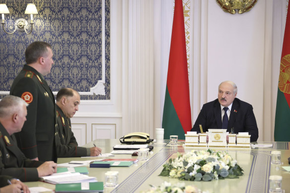 Belarusian President Alexander Lukashenko (right) attends a meeting with military top officials in Minsk.
