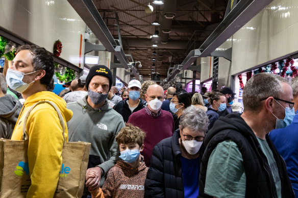 Melburnians wear face masks as they shop at the Queen Victoria Market.