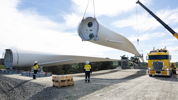 Workers unload the turbine blade after its long journey.