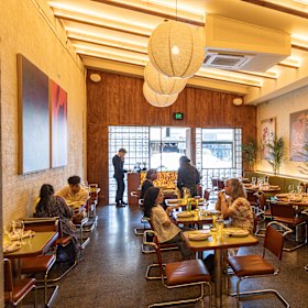 Tyga’s long room spills from a bar zone with DJ decks to a charcoal-fired open kitchen.