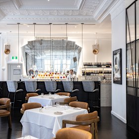 The restaurant’s bar seating, pictured, or diners can enjoy a drink in the Member’s Bar on the mezzanine below.