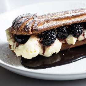 Bignè: a dressed-up eclair layered with cherries in syrup, white chocolate cream and blackberries.
