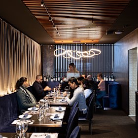 The fifth-floor restaurant is a chic, sleek, blue-velvet cave with lamp-lit tables.