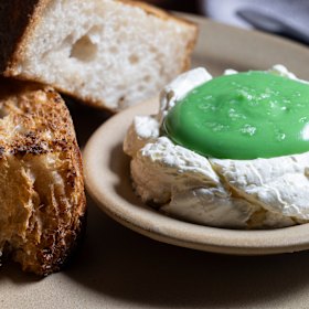 Tyga’s kaya toast is made with toasted sourdough (left), butter whipped with coconut custard, and a pool of pandan cream.
