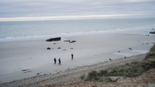 French police officers patrol  a beach in the search for migrants in northern France last week. 