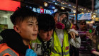 Volunteer medics assist an unwell press member during Christmas night in Mongkok district in Hong Kong.