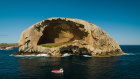 A Pennicott Wilderness Journeys craft swings by Skull Rock.