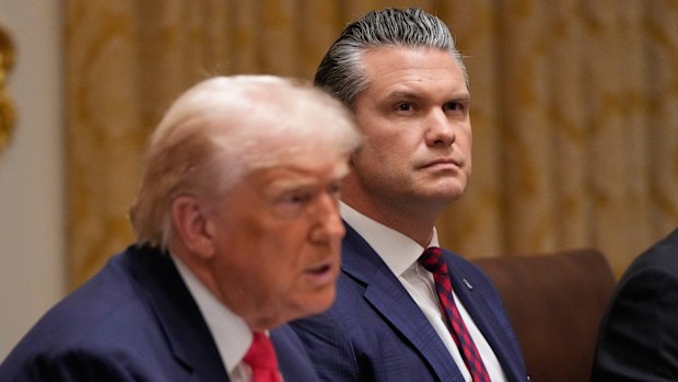 US President Donald Trump speaks during a cabinet meeting at the White House, on Tuesday as War Secretary Pete Hegseth looks on.