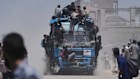 Palestinians ride on an aid truck heading into Gaza City on Tuesday.