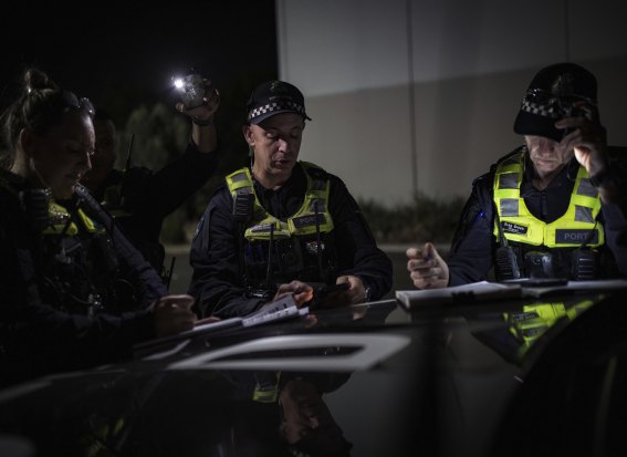 Senior Sergeant Nicole Beale, Acting Sergeant Paul Harris and Sergeant Greg Green work on plans for an operation.