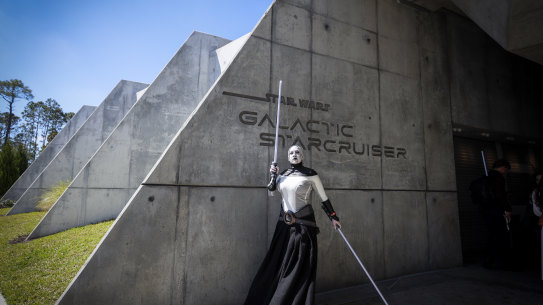 Orlando, Fla - March 01: Maggie Duckworth, of St. Louis, MO, poses as Asajj Ventress character, as the first passengers arrive for the two-day Walt Disney World Star Wars Galactic Starcruiser, which is a live action role playing game that doubles as a high-end hotel in Orlando, Fla. The event is billed as Halcyon’s 275th anniversary voyage across the galaxy. at Walt Disney World Star Wars Galactic Starcruiser in Orlando, Fla on Tuesday, March 1, 2022. First Order lieutenant Harman Croy and his garrison of stormtroopers patrol the ship. Guests arrive at Batuu, a destination for a planet excursion. Players use a data pad to play the immersive game while they participate in activities such as light saber training. (Allen J. Schaben / Los Angeles Times via Getty Images) Getty image for Traveller. Single use only.