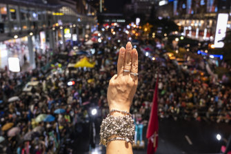 Protesters give the three-finger salute at an anti-government gathering in Bangkok on October 31.