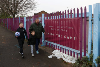 Aston Villa fans walk away from the stadium after the match was postponed.
