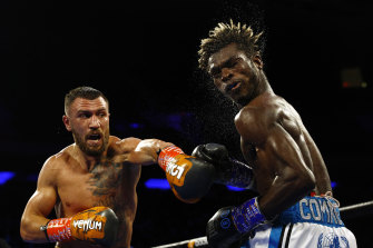 Vasiliy Lomachenko whacks Richard Commey in their bout earlier this month.
