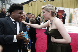 Greta Gerwig, right, talks to Jerry Harris on the red carpet at the Oscars at the Dolby Theatre in Los Angeles in 2020.
