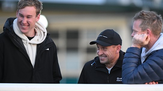 Melbourne Cup winning trainer Chris Waller (centre), who prepares Soulcombe, chats with part-owners, Richmond stars, Tom Lynch and Jack Riewoldt.