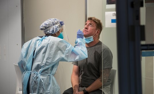 Passengers are tested at Melbourne Airport on Saturday.