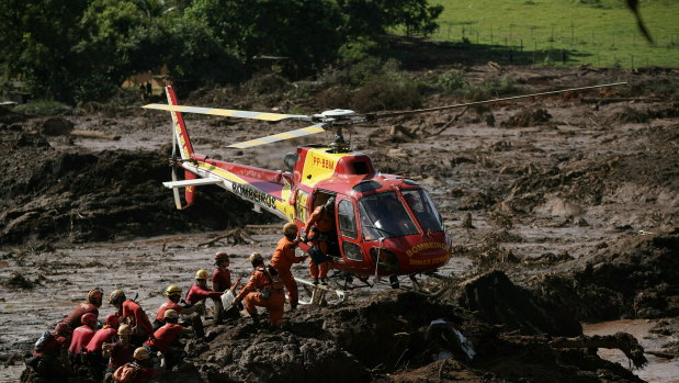 Firefighters receive supplies as they search for victims in the muddy aftermath of the Brumadinho dam disaster in Brazil.