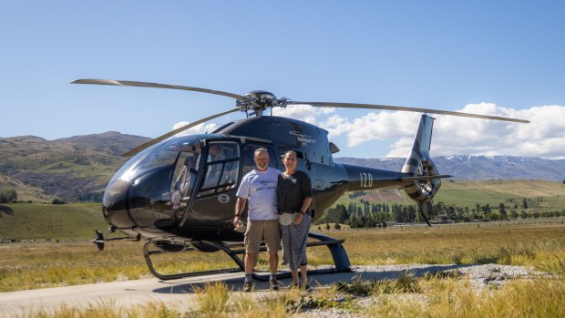 Jolanda Foale and her partner Richard with the helicopter they fly over scenic Queenstown and the surrounding region.