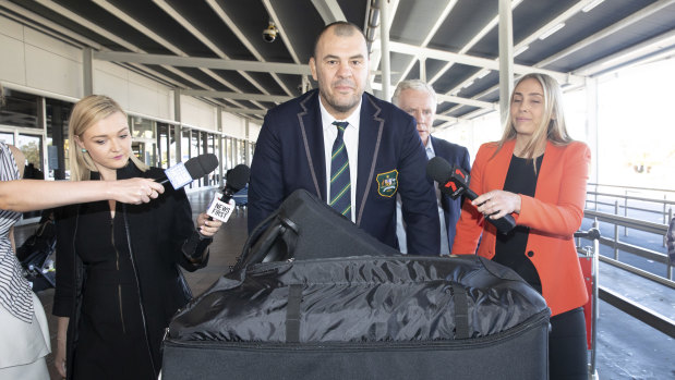 Cheika arrives at Sydney airport to be greeted by a sizeable press pack on Tuesday.
