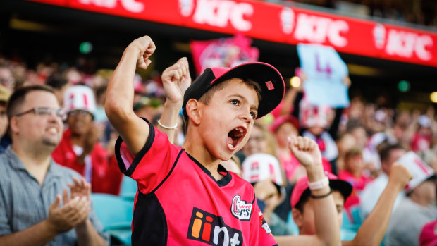 A young Sixers fan cheers on his team during the final at a buzzing SCG. 