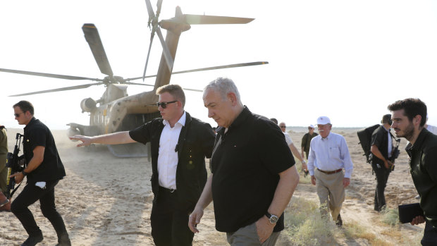 Israeli Prime Minister Benjamin Netanyahu, centre, and then US National Security Advisor John Bolton, back right, come out of a military helicopter after a flight in the Jordan Valley between the Israeli city of Beit Shean and the Palestinian city of Jericho, West Bank, in June.