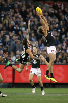 Exposing the gaps: Charlie Curnow takes a grab in front of Collingwood defender Jeremy Howe.