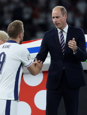 The Prince of Wales shakes hands with Harry Kane.