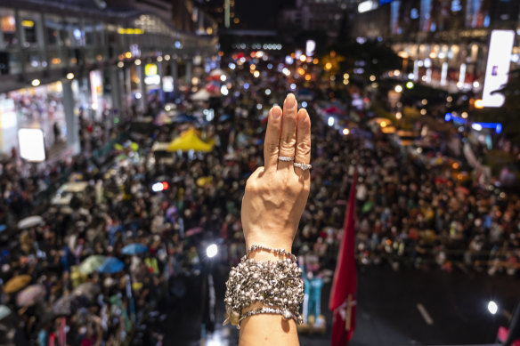 Protesters give the three-finger salute at an anti-government gathering in Bangkok on October 31.