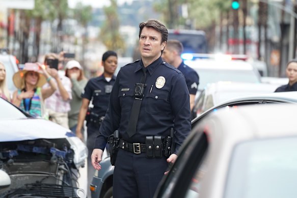 Not giving up his day job: Nathan Fillion stars as police officer John Nolan in The Rookie.