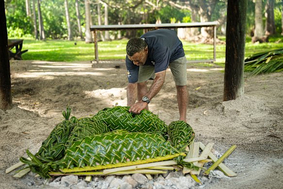 A traditional lovo – or earth oven – involves palm-frond-wrapped pork, fish and potatoes stacked among hot rocks.