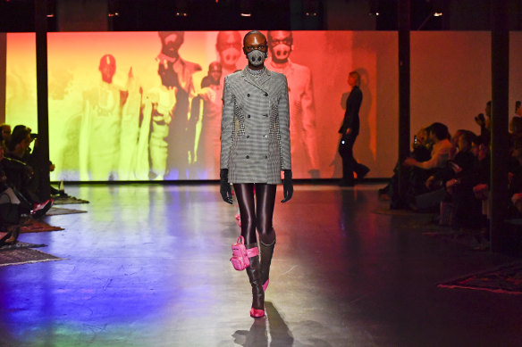 A model wears a matching mask and suit during the Marine Serre Ready to Wear fashion show as part of Paris Fashion Week.