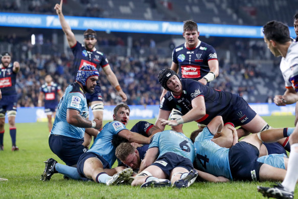 Rebels prop Matt Gibbon scores a try against the Waratahs.