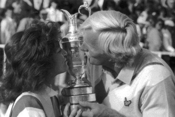 British Open winner Greg Norman and wife, Laura, kiss the trophy.