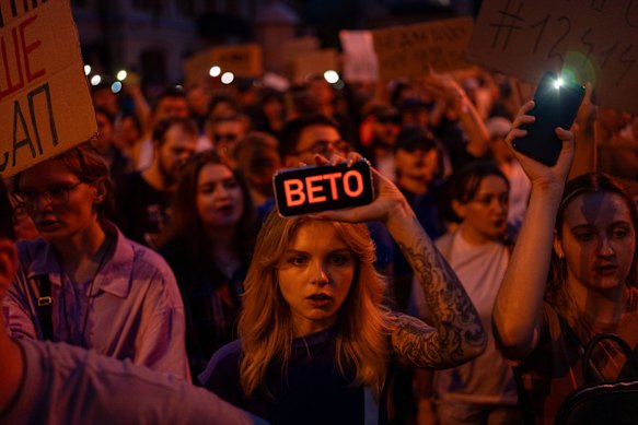 A woman holds a phone during a protest in central Kyiv on Tuesday against a law aimed at regulating anti-corruption bodies.