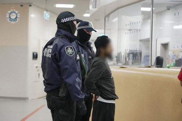Neil Prakash is escorted by Australian Federal Police officers in Darwin.