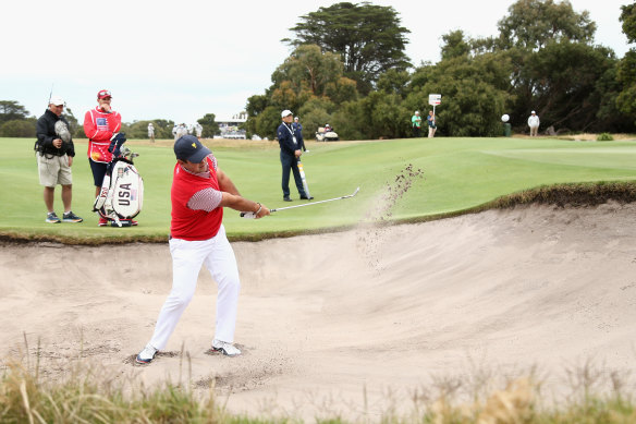 'Captain America' Patrick Reed plays out of the bunker on day one in Melbourne.