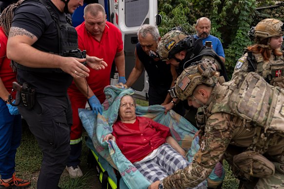 Police and medics evacuate Olha Trush, 86, from Yarova, a village hit by a Russian airstrike that killed dozens of civilians, in Sloviansk, Donetsk region, on Tuesday.