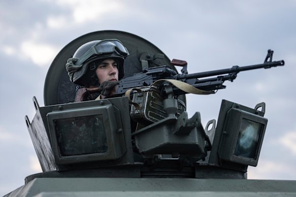 A Ukrainian National guard soldier guards a mobile checkpoint together with the Ukrainian Security Service agents and police officers during a joint operation, in Kharkiv, Ukraine, on Thursday.