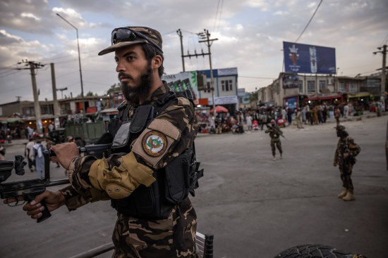 Taliban fighters control their positions near the entrance to the airport in Kabul on August 30, 2021.