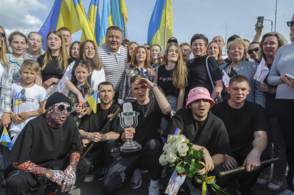 Oleh Psiuk, second from right, frontman of Ukraine’s Kalush Orchestra, winners of the Eurovision Song Contest, and his band posed with the trophy in Krakovets, at the Ukraine border with Poland, in May. 