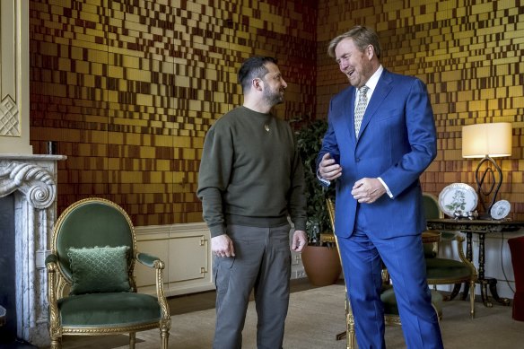 Ukraine’s President Volodymyr Zelensky, left, and Dutch King Willem-Alexander, right, talk during a meeting in The Hague.