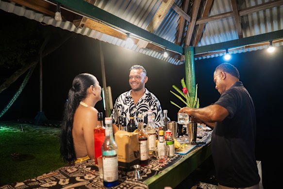 Guests enjoy a beach bar.