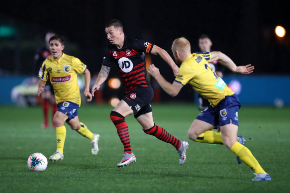 Mitchell Duke pushes ahead for the Wanderers.